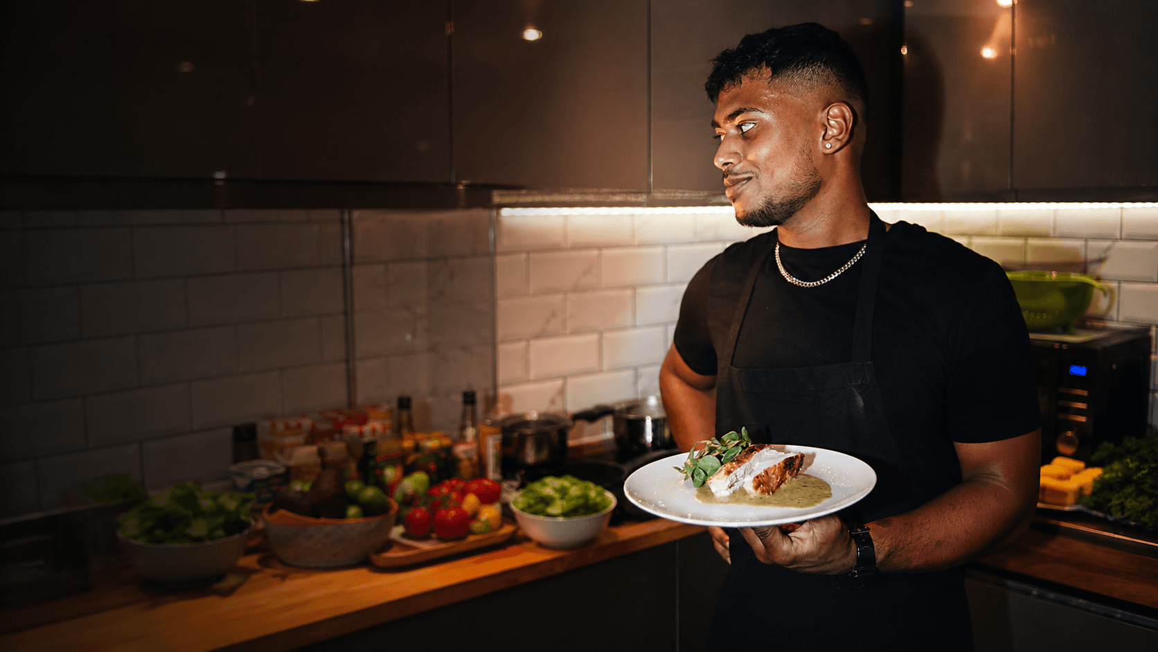 Gavin from Harah's Kitchen holding a plated dish